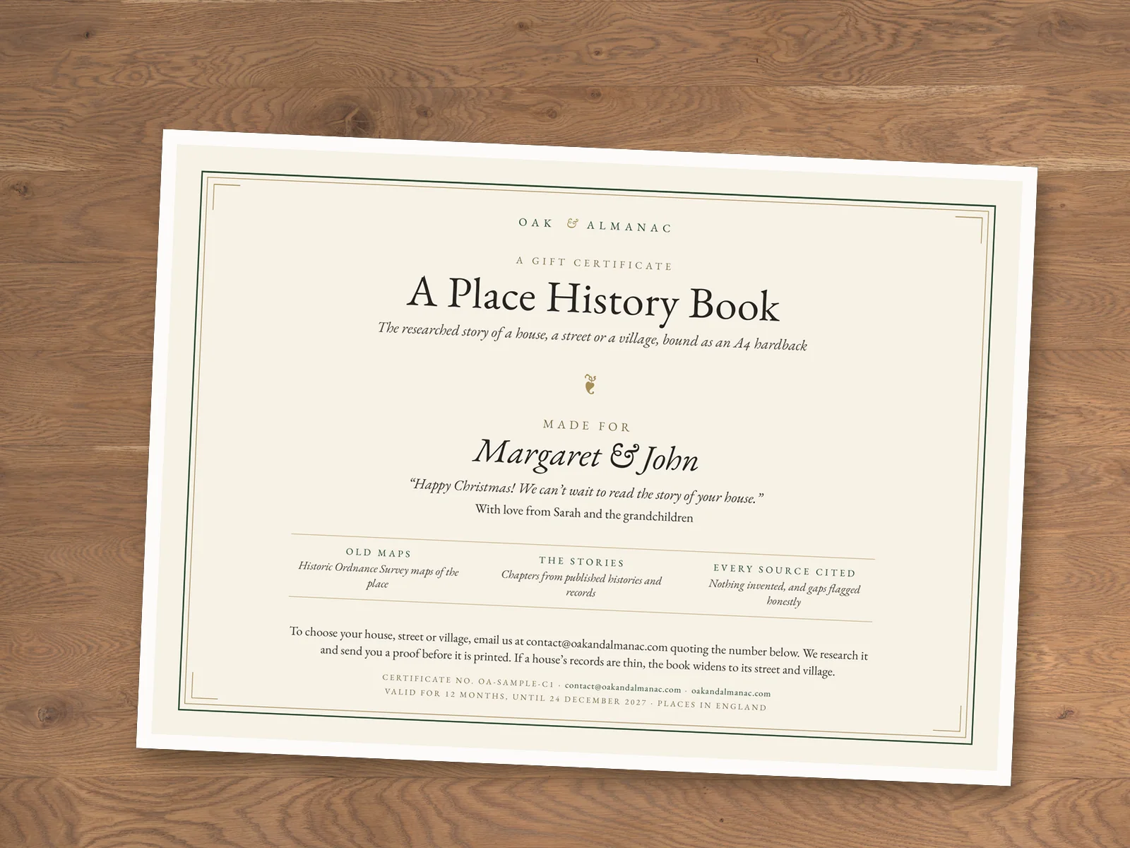 Our example Place History Book gift certificate (sample names), printed at home on A4 and lying on an oak table